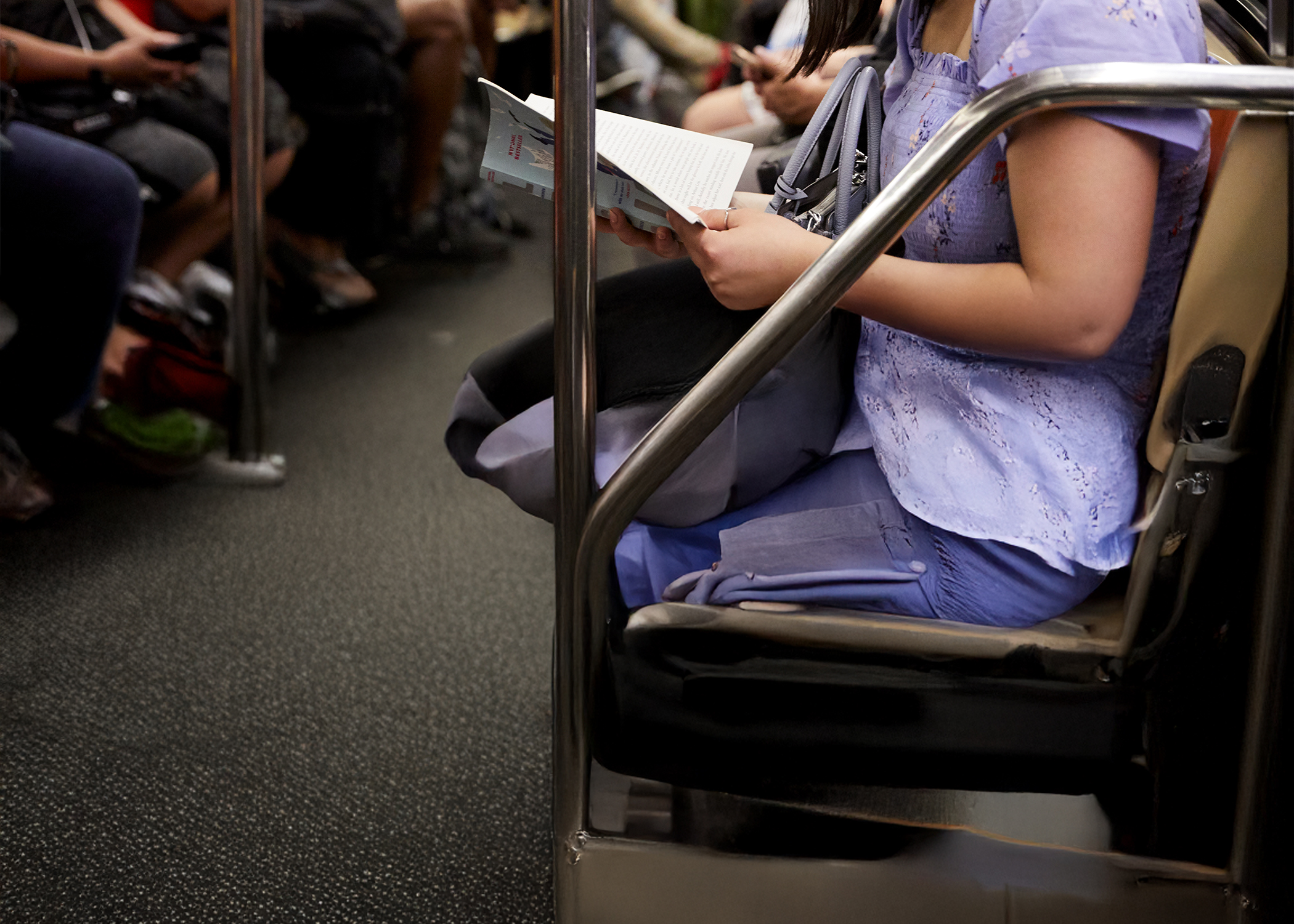 Someone reading on the subway.
