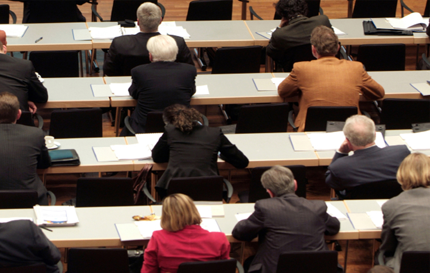People in professional attire sit in rows