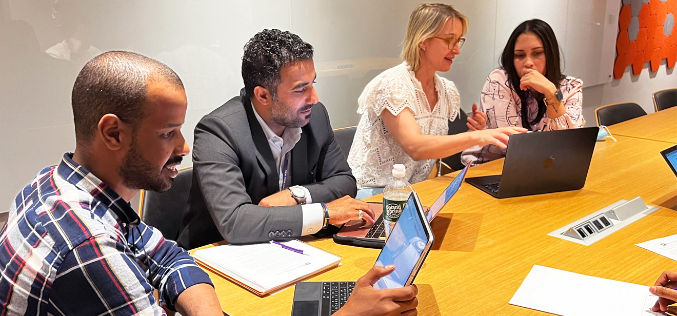 People sit at a table and work together.