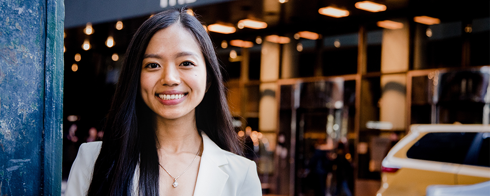 Woman smiling in front of hotel entrance