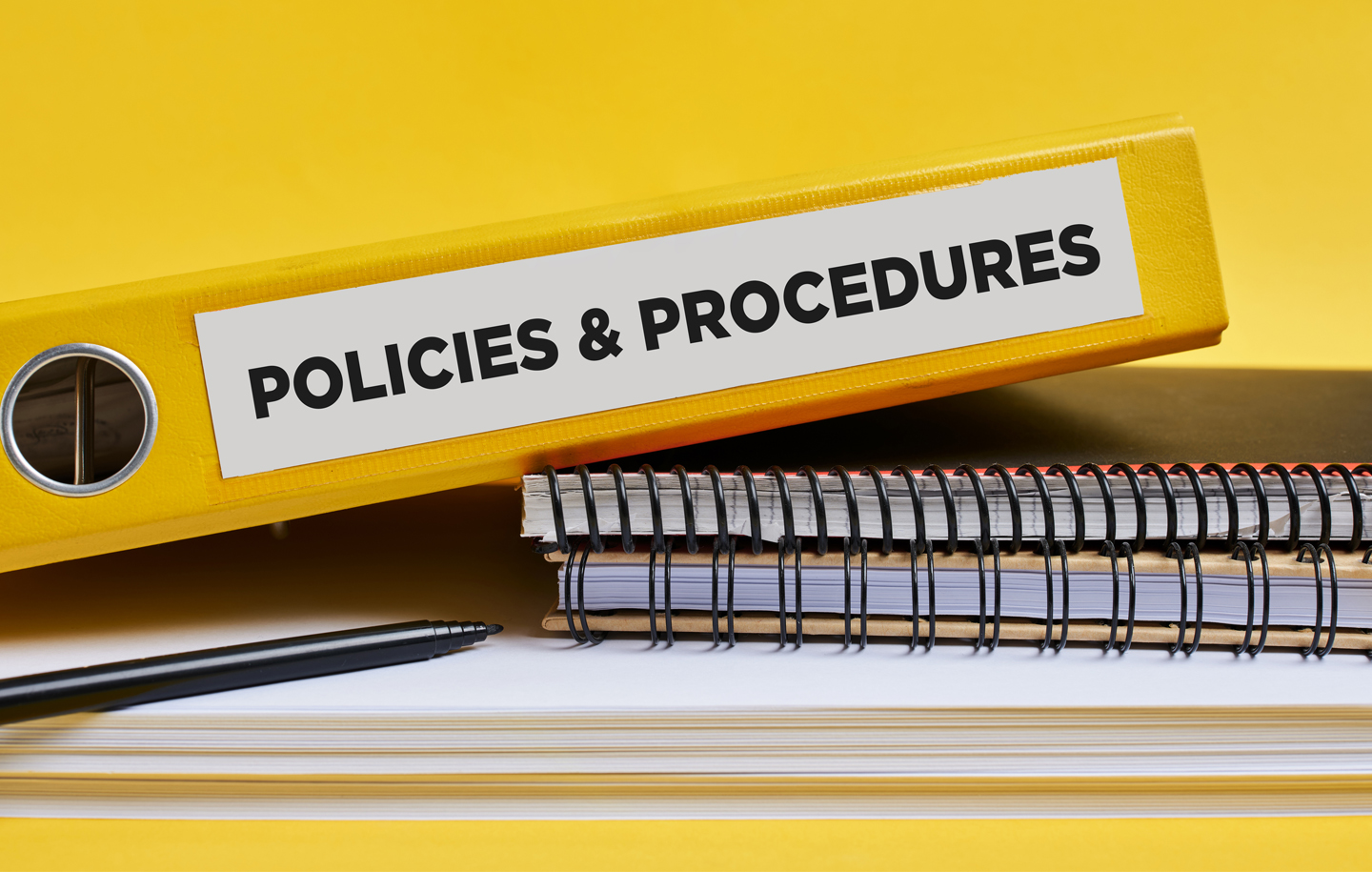 Faculty Policies and Procedures image of notebooks